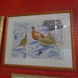 A glazed and framed watercolour study of pheasants in the snow