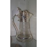 A silver plated and glass claret jug with etched detail