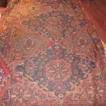 A Persian hand knotted and flat weave rug the purple ground with geometric motifs and