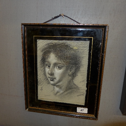 A charcoal portrait heightened in white within an eglomised frame signed T. O'Donnell