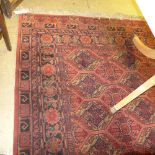 A hand knotted Persian style rug the red