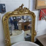 A gilt wall hanging mirror within ornate gilt frame