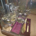 A collection of silver plate including tea caddy, vases, teapot and cased fish serves