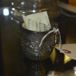 A Georgian silver creamer with embossed