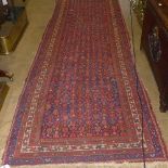 A hand knotted Persian runner the blue g