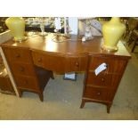 A mahogany kneehole desk fitted seven drawers on swept supports