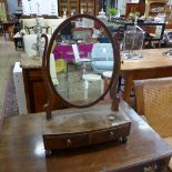 A Georgian mahogany toilet mirror the oval swing plate above drawer on bow feet