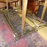 A metal X-framed coffee table with glass