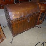 A metal dome top trunk with hoop handle on scroll feet