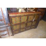 A Chinese hand painted side cabinet with various compartment having drop handles