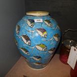 A large pottery vase with aquatic decora