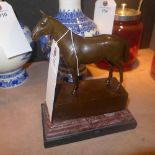 A bronzed figure of a horse on marble base