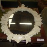 A cream painted mirror with acorn form frame