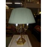 A brass three branch table lamp with shade