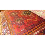 A fine South Persian Lori rug 210 cm x 127 cm repeating ghoul motifs on a terracotta field within