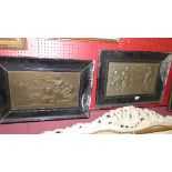 A pair of late C19th copper and a white metal wall plaques depicting figures in ebonised frames (a/