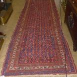 A hand knotted Persian runner the blue ground with geometric motifs