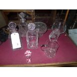 A collection of crystal glass items including three decanters with stoppers and three etched