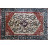 A good hand woven Abadeh Persian carpet, with a central hexagonal ivory field and floral