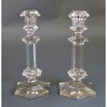 A pair of early C20th rose tinted glass candlesticks, with hexagonal column and foot, the foot