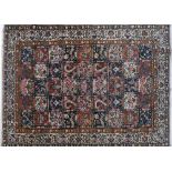 A hand woven Bakhtiari Persian carpet, the field with polychrome compartments enclosing floral