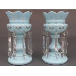 A pair of Victorian sky blue opaque glass lustres, the castellated top above facet cut clear glass