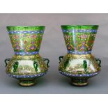 A pair of Mamluk style green and enamelled glass mosque lamps, the bulbous body on short splayed