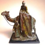 A cold painted spelter camel and carpet seller group, in the style of Franz Bergman.  Height 19 cm x