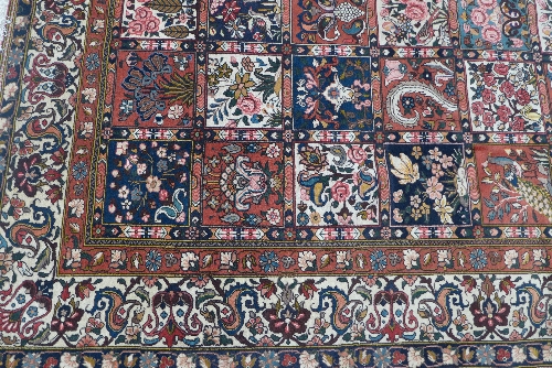 A hand woven Bakhtiari Persian carpet, the field with polychrome compartments enclosing floral - Image 2 of 3