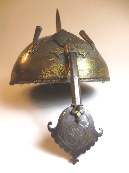 An C18th Persian steel helmet, with central spike and twin plume holders, nasal bar, with allover