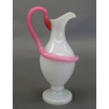 An Edwardian opaline glass ewer, fitted with a snake form handle in pink opaque glass (wear to