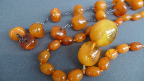 Two strings of semi-translucent butterscotch amber beads, early C20th, one with graduated beads - Image 2 of 3