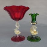 A Venetian red glass comport, the scalloped bowl on dolphin support and circular foot, together with