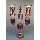 A late C19th Bohemian ruby glass candelabra, the twin scroll branches fitted with waisted