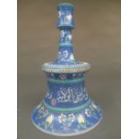 A Continental porcelain candlestick, the blue glaze with foliate decoration, the tapering