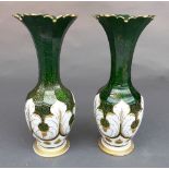A pair of late C19th Bohemian seaweed glass vases, the gilt bordered flared rim above elongated neck