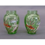 A pair of early C20th green glass globular form vases with relief decoration depicting fish swimming