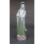 A mid C19th famille rose porcelain Guanyin, dressed in a foliate decorated flowing robe (lacks