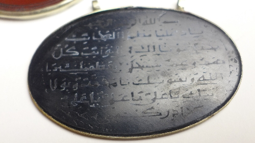 Two C19th Islamic agate pendants, with Koranic verse within white metal mount, the largest 7.5 cm x - Image 2 of 4