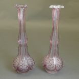 A near pair of Bohemian ruby flash stem vases of mallet form with reserves and an elongated neck.