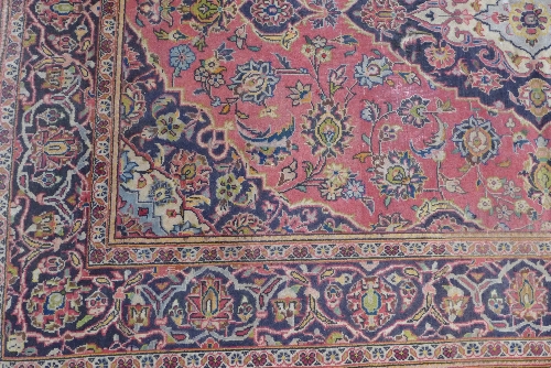A Kashan rug, the cerise ground with indigo and ivory lobed pole medallion enclosed by similar - Image 2 of 3