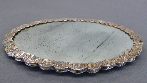 A Turkish mirror, the embossed silver oval shaped back with sunburst floral design, complete with - Image 2 of 2