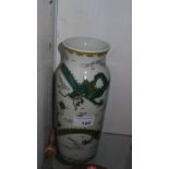 A Chinese vase glazed white and decorated with flying dragons