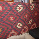 A Persian handmade kelim carpet the rouge ground with repeating geometric motifs 250 cm x 155 cm