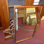 A looking glass with rectangular plate with leafy gilt frame with urn surmounts