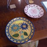 Four Majolica chargers brightly glazed and with pierced detail