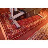 A fine North East Persian Turkoman rug, 205cm x 110cm, repeating Goul motifs on a rouge field within