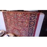 A Persian Keshan style runner the red field with repeating floral decoration in triple border 210