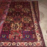 A fine North West Persian Bakhtar rug, 220cm x 145cm, repeating panel motifs of floral motifs within