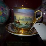 A C19th Continental porcelain cup and saucer with hand painted maritime decoration including